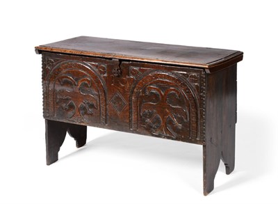 Lot 577 - A 17th Century Boarded Oak Chest, with hinged lid, the front carved with two arched panels...