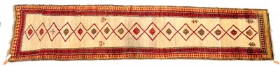 Lot 579 - Unusual Kurdish Runner North West Persia The ivory field with a column of linked diamond medallions