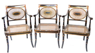 Lot 597 - A Set of Three Bronze and Gold Painted Regency Armchairs, by John Gee, with cane panel oval...