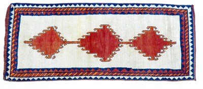 Lot 600 - Gabbeh Rug South West Persia The plain ivory field with three latch hook linked medallions...