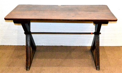 Lot 602 - A ''Tavern Table'', the rectangular oak top on an X frame base, the ends joined by an iron tie-bar