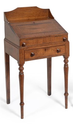 Lot 623 - A Small Early 19th Century Oak Desk on Stand, having a raised ledge back, hinged slope and...