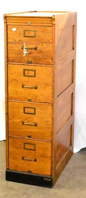 Lot 625 - An Early 20th Century Light Oak Filing Cabinet, with four drawers, brass handles and...