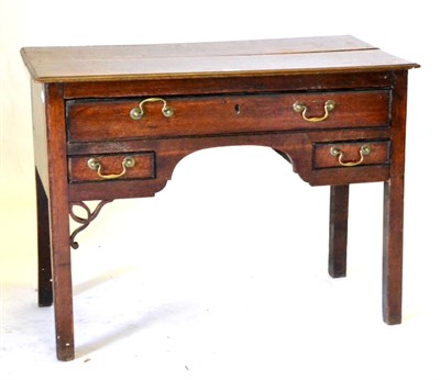 Lot 627 - A George III Oak Lowboy, the rectangular top over one long and two short drawers about the...