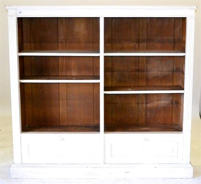 Lot 628 - A Pair of White Painted Pine Open Bookcases, each with a plain cornice over adjustable shelves...