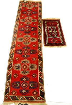 Lot 630 - Narrow Yagebedir Runner West Anatolia The blood red field with a column of hooked medallions...