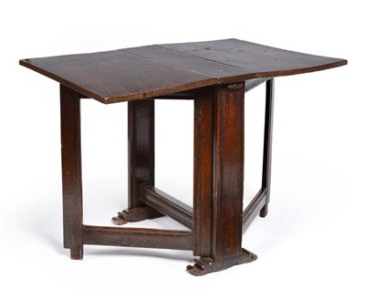 Lot 637 - An 18th Century Oak Gateleg Table, the rectangular top on scratch moulded end supports and...