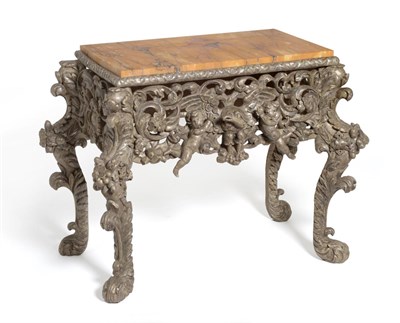 Lot 652 - A Late 17th Century Carved Pine and Silvered Cabinet Stand, the apron carved with an eagle...