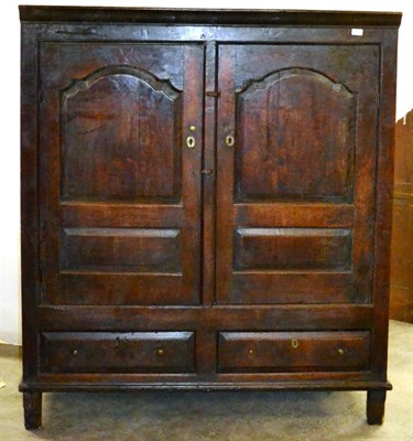 Lot 658 - An 18th Century Joined Oak Hanging Press, with two arched panelled doors enclosing hanging...