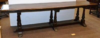 Lot 669 - A Large 16th Century Style Walnut Refectory Table, with a one piece plank top raised on three pairs