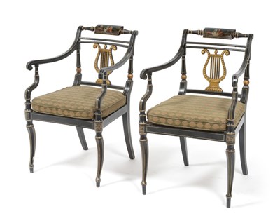 Lot 687 - A Pair of Regency Japanned Armchairs, with tablet backs, lyre splats, caned seats and sabre...