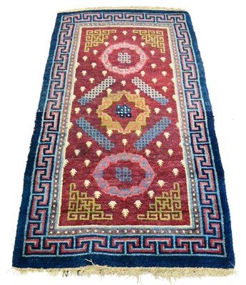 Lot 689 - Modern Gabbeh Rug South West Persia The abrashed raspberry field enclosed by polychrome...