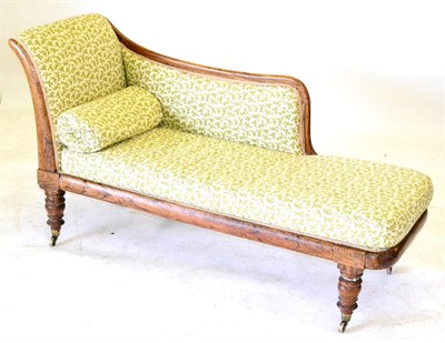 Lot 696 - An Early Victorian Simulated Rosewood Chaise Longue, circa 1850, recovered in cream and green...