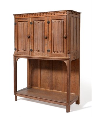 Lot 699 - A Thomas ''Gnomeman'' Whittaker Oak Cupboard, the shaped rectangular top over three carved...