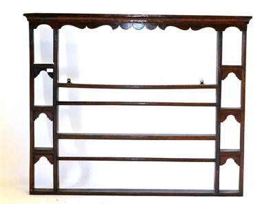 Lot 712 - An Oak and Pine Hanging Plate Rack, with a moulded cornice and shaped frieze over three shelves...