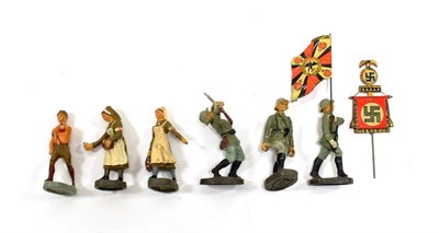 Lot 3522 - Elastolin Figures SA Man with tin NSDAP banner, three German soldiers: marching with tin...