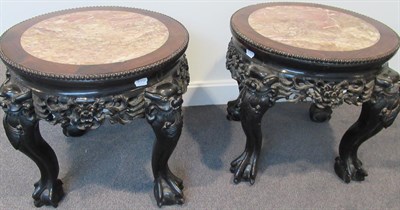 Lot 734 - A Matched Pair of Early 20th Century Chinese Hardwood and Pink Marble Plant Stands, each with a...