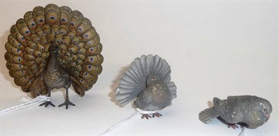 Lot 897 - Peacock, unmarked, standing in courtship display, 8cm high; and Pair of Fantail Doves, unmarked, in