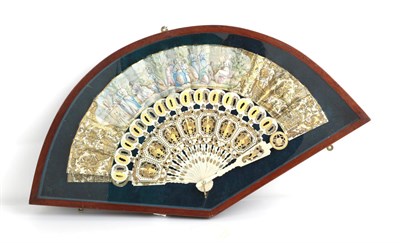 Lot 1079 - A Mid-19th Century Ivory Fan, the carved and well-shaped monture gilded in two shades of gold....