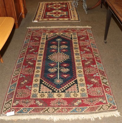 Lot 1193 - Kars rug, the raspberry field with two cruciform medallions enclosed by stellar motif borders,...