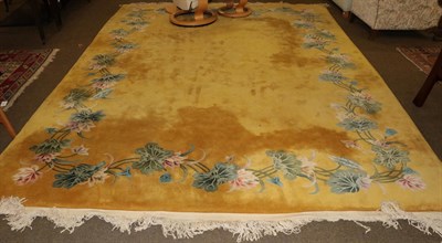 Lot 1196 - A Chinese carved carpet, the lemon field enclosed by naturalistic flower borders, 370cm by 276cm