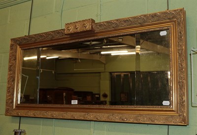 Lot 1207 - A Regency style gilt and gesso triple plate overmantle mirror, 115cm wide