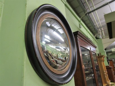 Lot 1209 - A pair of circular ebonised convex mirrors