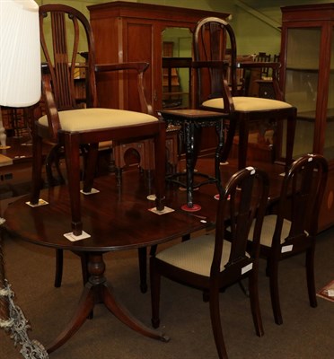 Lot 1229 - A reproduction twin pedestal dining table with six chairs (including two carvers)