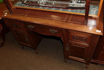 Lot 1232 - An Edwardian walnut leather top writing desk, 121cm wide