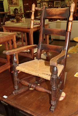 Lot 1240 - A mid 19th century elm child's chair with rush seat