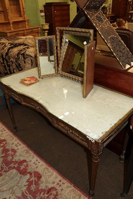 Lot 1241 - A late 19th century gilt decorated dressing table fitted three frieze drawers, on fluted legs,...