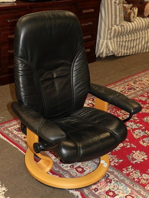 Lot 1246 - A small Ekornes stressless reclining lounge armchair, in black leather, 70cm by 56cm by 96cm