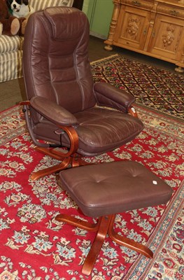 Lot 1247 - A Danbury brown leather chair and footstool