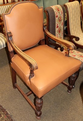 Lot 1254 - An early 20th century carved oak armchair covered in leather