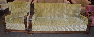 Lot 1261 - An early 20th century Danish oak framed three-seater settee with matching armchair, carved...