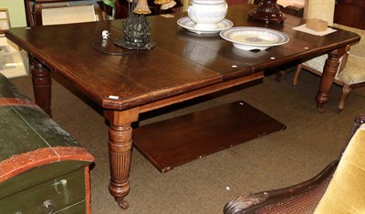 Lot 1299 - A late Victorian oak extending dining table, with four additional leaves, on turned and reeded...