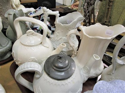 Lot 5 - Fifteen Victorian relief moulded jugs and teapots etc (14) (two trays)