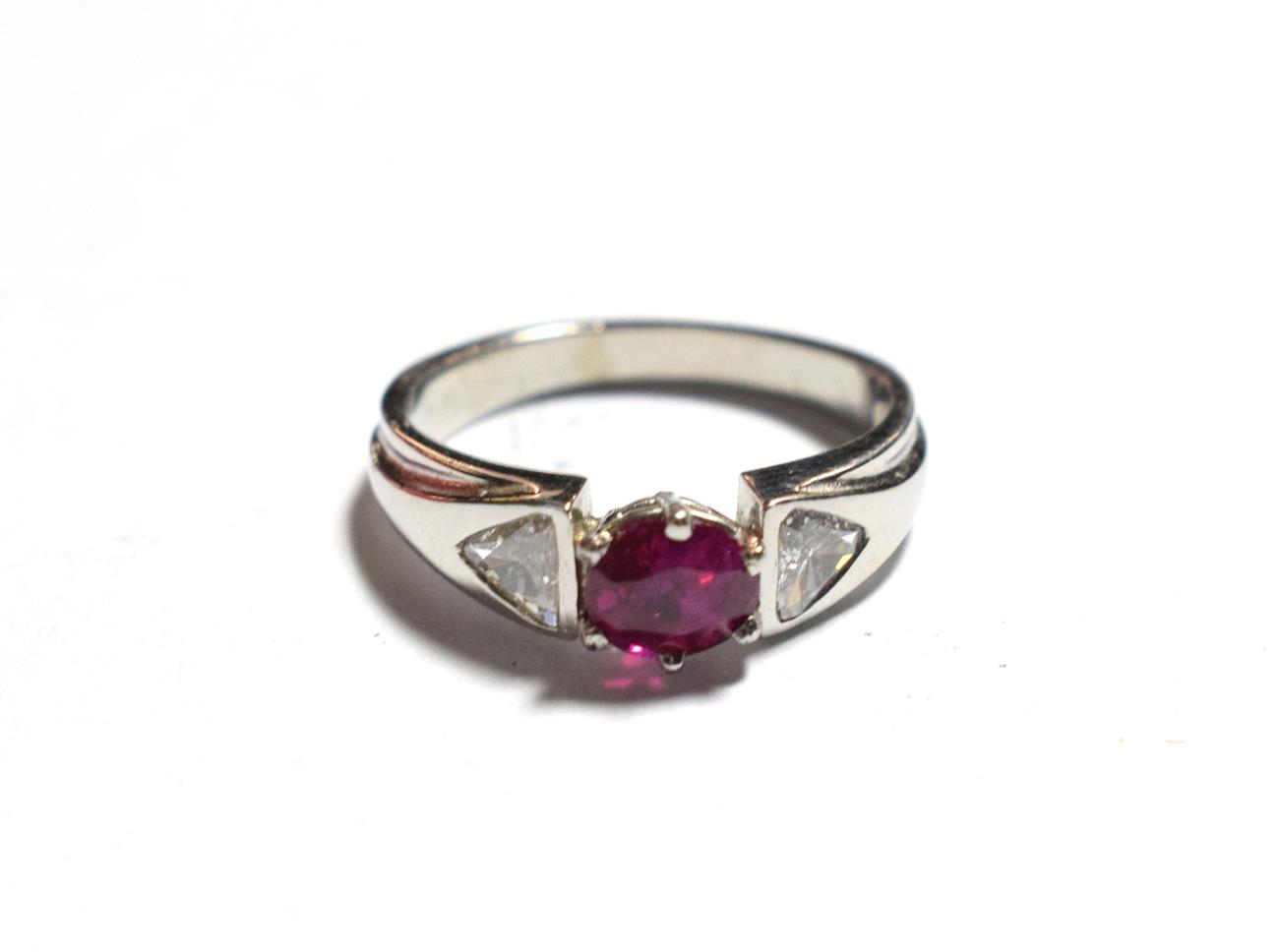 Lot 51 - A ruby type and diamond ring, an oval cut ruby type in a white claw setting, flanked by...