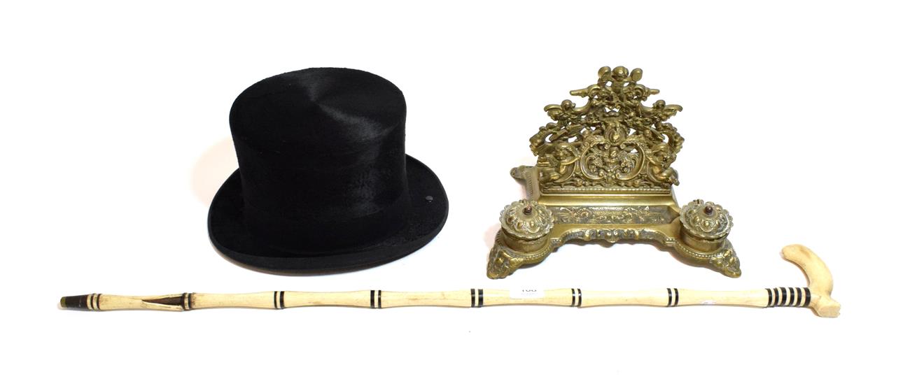 Lot 108 - Lock & Co silk top hat, together with a brass desk tidy, and a bone and ebony cane