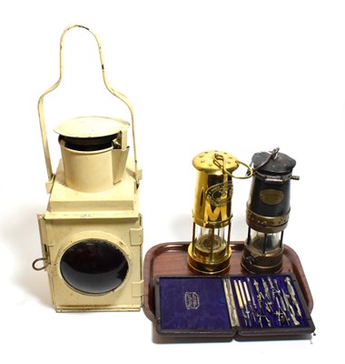 Lot 161 - A GWR signal lamp, two miners lamps and a Stanley compass set (4)
