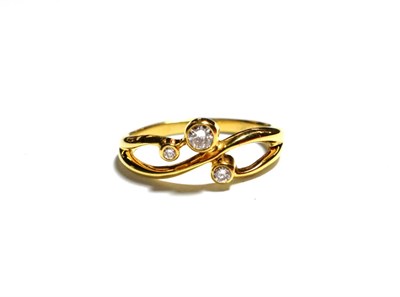 Lot 172 - An 18 carat gold diamond ring, three round brilliant cut diamonds in yellow rubbed over...
