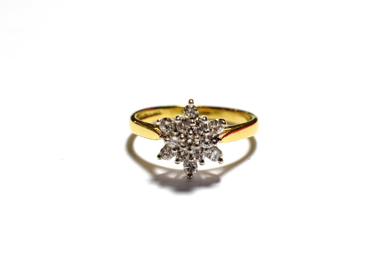 Lot 174 - An 18 carat gold diamond cluster ring, a central round brilliant cut diamond within two borders...