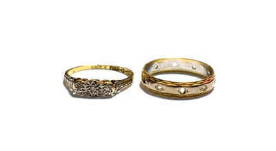 Lot 178 - An 18 carat gold eternity ring (a.f.), finger size N1/2; and a three stone ring stamped '18CT'...