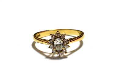 Lot 189 - An 18 carat gold diamond cluster ring, an oval cut diamond within a border of round brilliant...