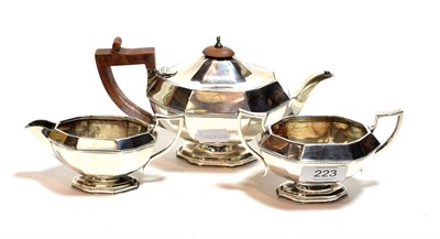 Lot 223 - A George VI three-piece silver tea-service, maker's mark HR, London 1937, each piece facetted...