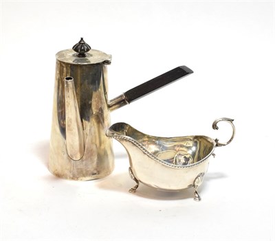 Lot 226 - A George V silver sauceboat and a George VI silver hot chocolate pot, the first by Collingwood...