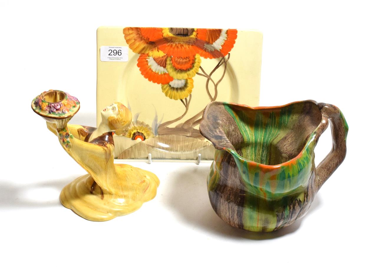 Lot 296 - A Clarice Cliff Bizarre candlestick, a Bizarre rectangular plate, Clarice Cliff Le Bon Dieu jug (3)