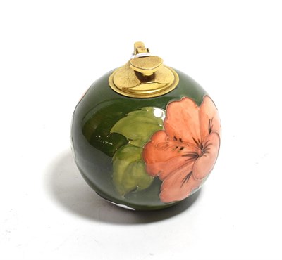 Lot 312 - A 1950's Walter Moorcroft pottery table lighter in the Hibiscus pattern on a green ground, 11cm...