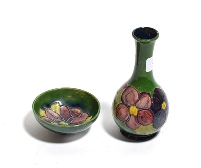 Lot 313 - A Walter Moorcroft bottle vase, 15cm high; and a dish (2)