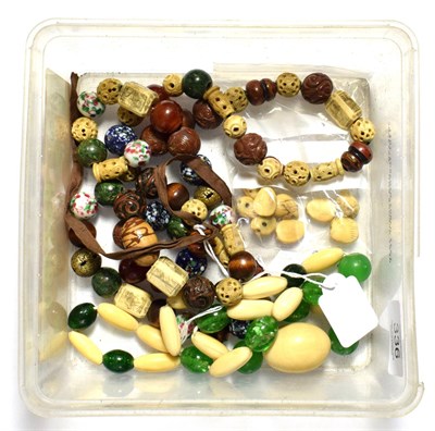 Lot 336 - A Chinese string of mixed beads, including ivory, porcelain, tiger's eye, jade etc late...